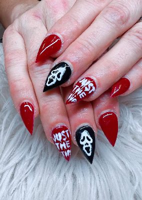 Long red stiletto nails with black accent nails, white screaming-mask faces, and bold white lettering.