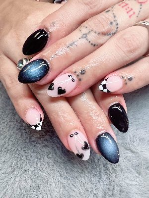 Medium almond nails mixing glossy black, blue cat-eye effects, pale pink heart art, and black-and-white checkerboard French tips.