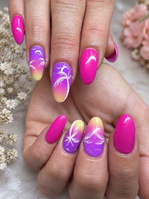 Long almond nails in vivid pink with purple-to-yellow ombre accents, white palm trees, and flying bird silhouettes.