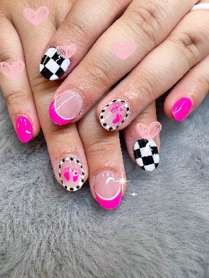 Short glossy oval nails combining hot pink polish, pink French tips, black-and-white checkerboards, paw prints, and dotted borders.