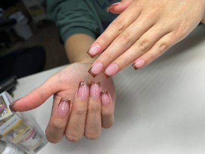 Medium square nails with a sheer pink base and glossy brown French tips on both hands.