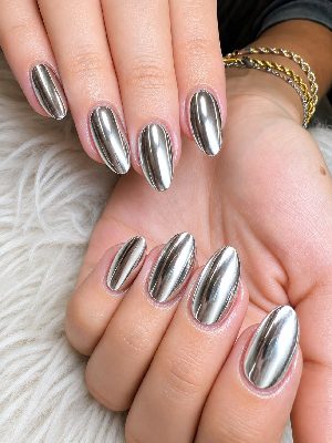 Two hands displaying medium almond nails with a highly reflective silver chrome finish.