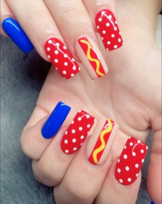 Square nails with red and white polka dots, blue accent nails, and hot dog-inspired accent art.
