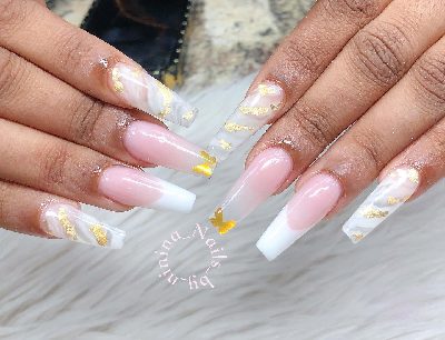 Extra-long pink coffin nails with white French tips, translucent white marble accents, scattered gold foil, and gold butterflies.