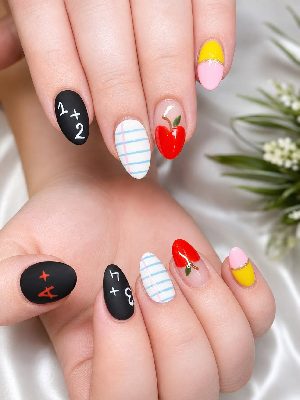 Medium oval nails with apples, chalkboard-style math equations, ruled paper, and pink-and-yellow pencil-inspired color blocking.